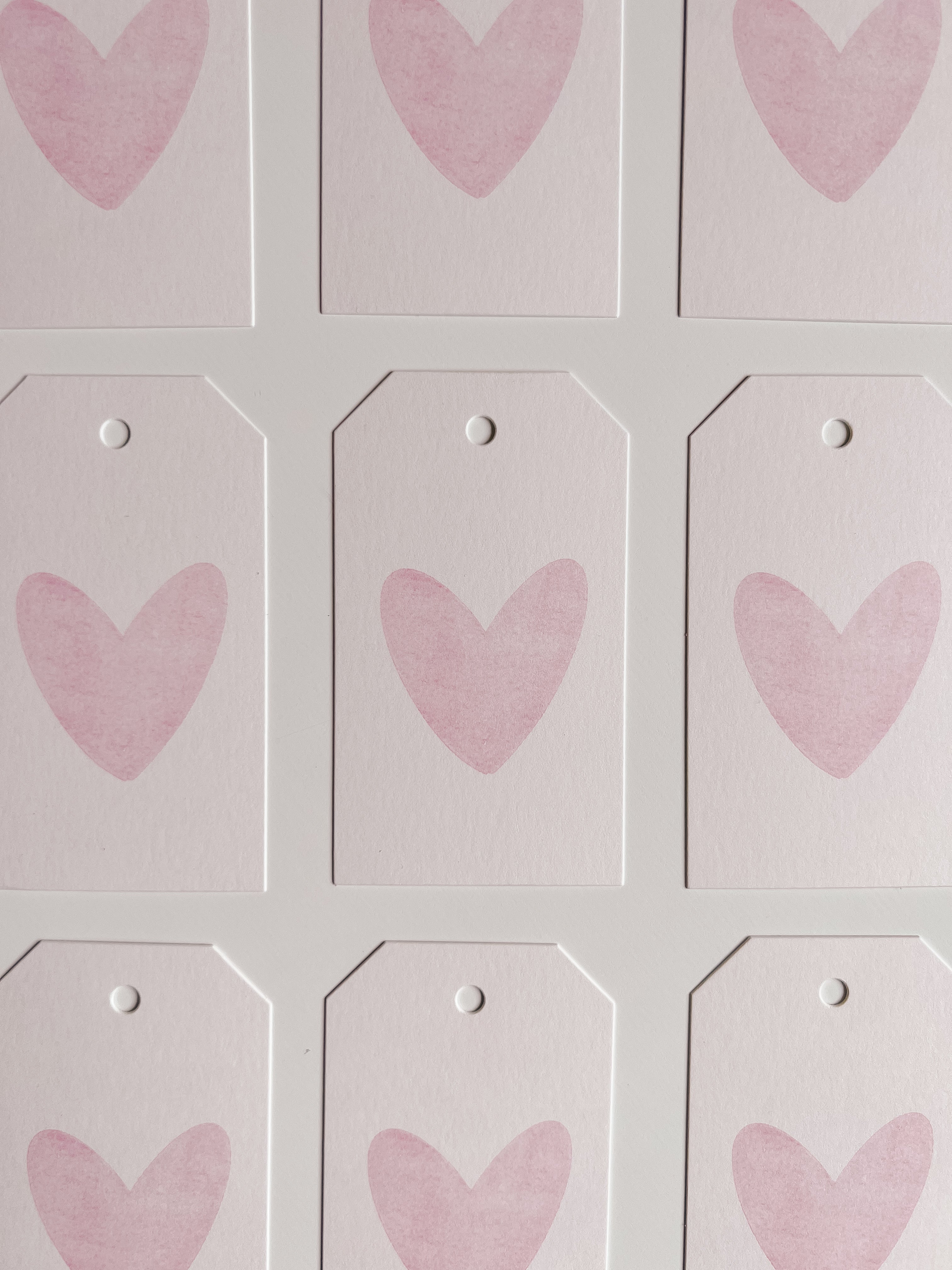 Pink heart gift tag on light pink background