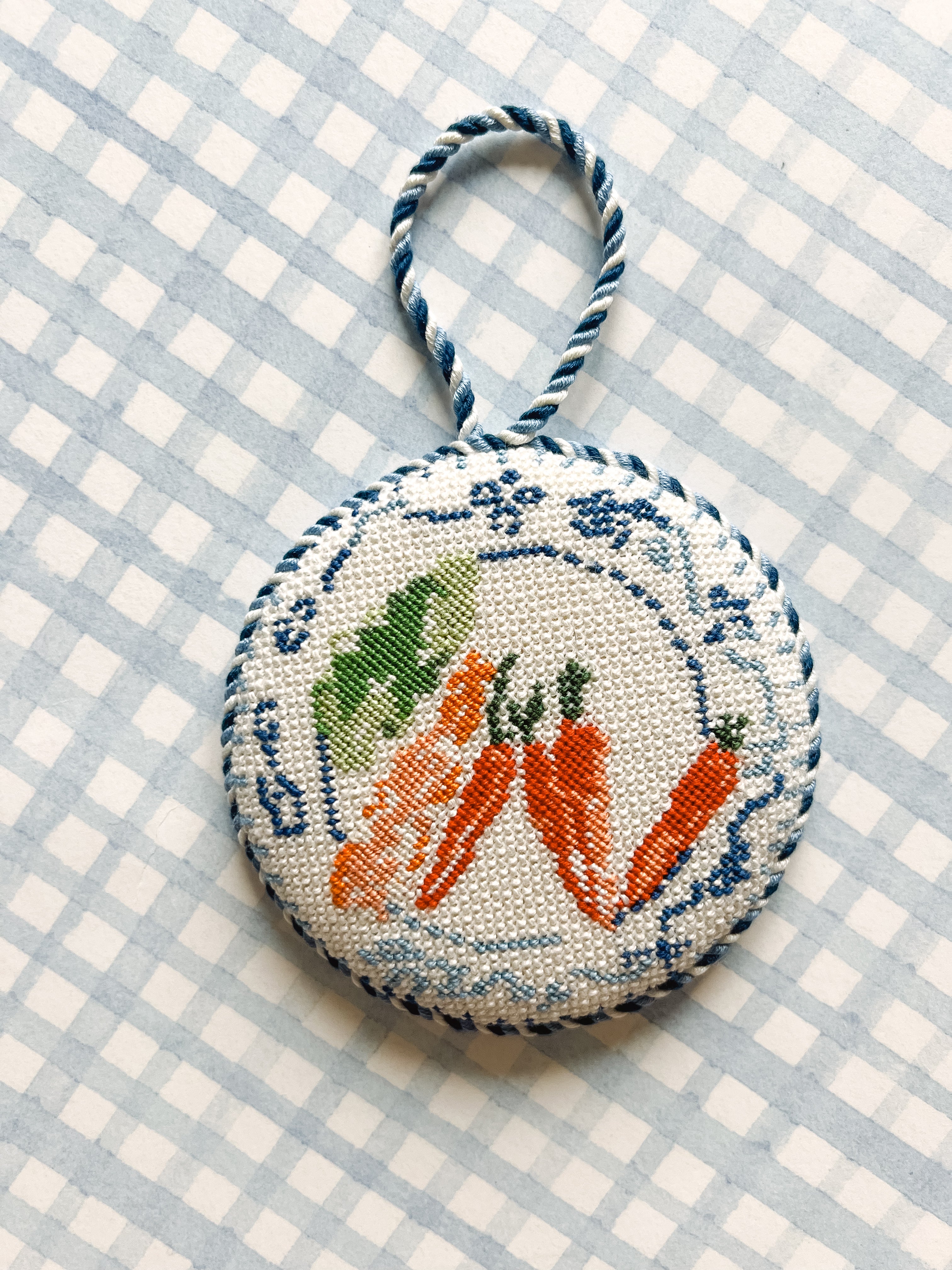 Hand-painted 4.5 inch round needlepoint canvas featuring blue and white china plate with garden vegetables in grandmillennial style