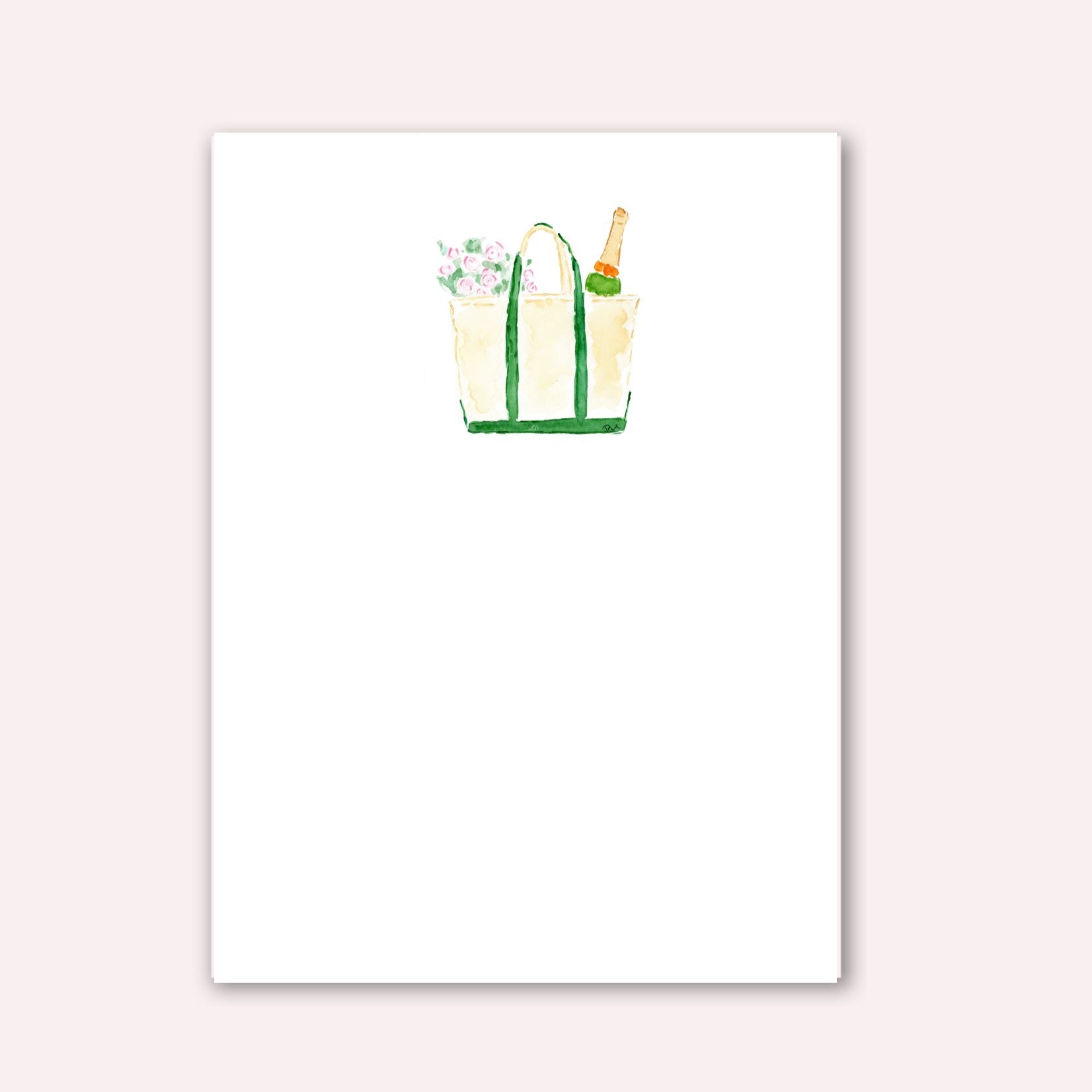 Notepad with tan boat and tote bag with green handles with flowers and champagne