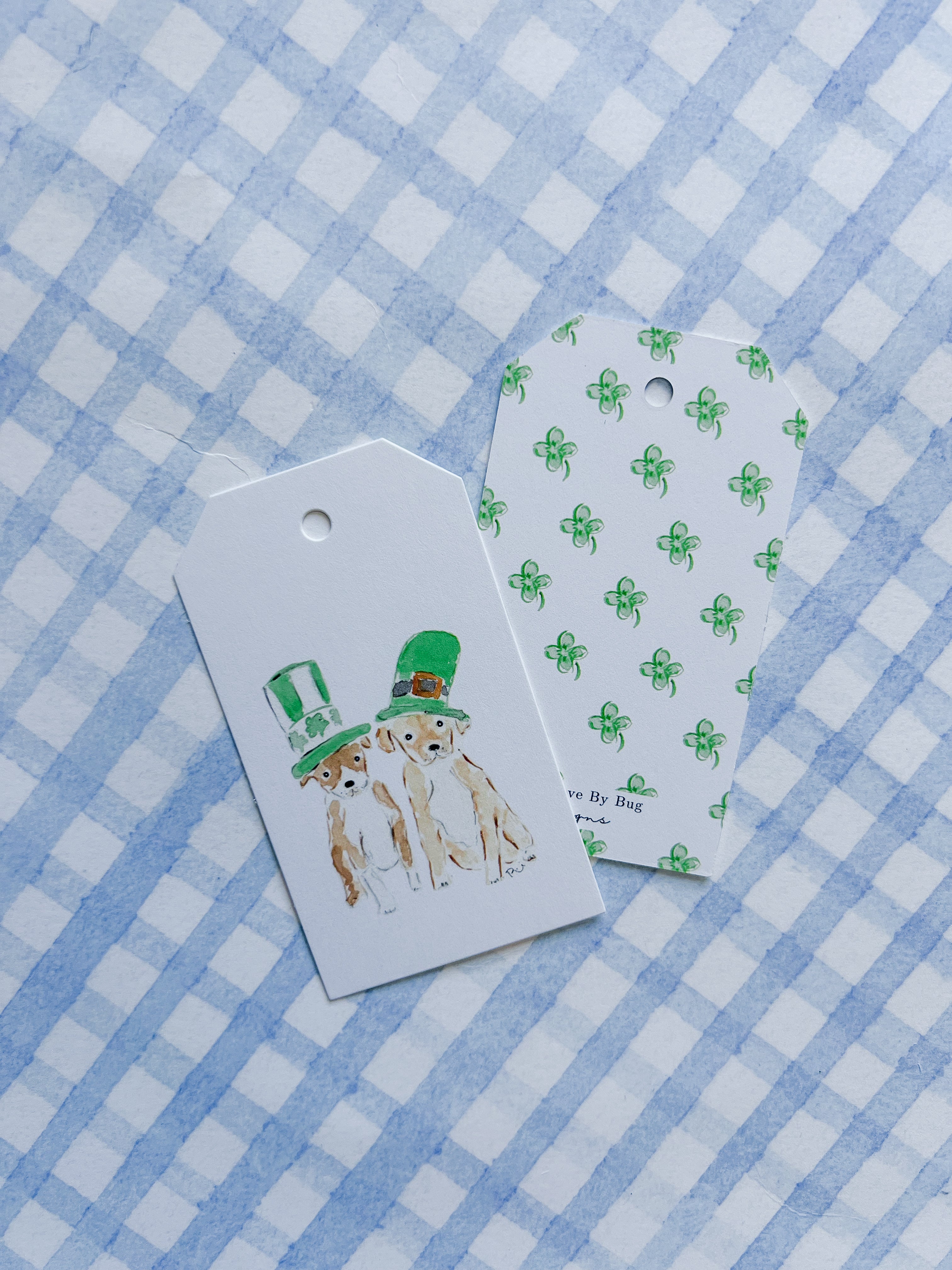 Two gift tags with dog illustrations on a blue and white checkered background